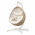Sillón colgante de ratán y acero con cojines beige